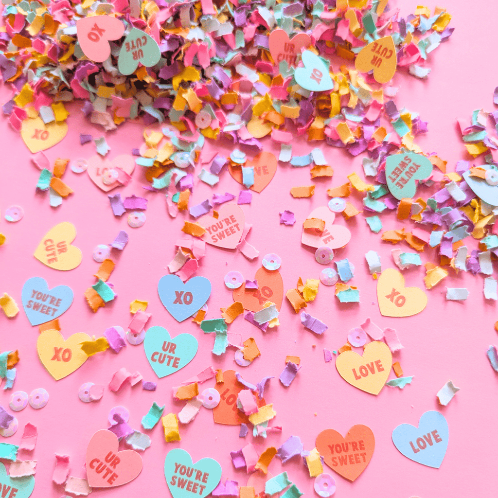 Pastel candy heart Valentine's confetti with conversation heart sayings