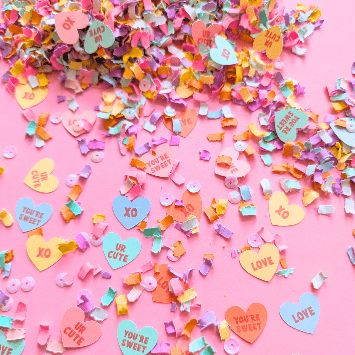 Pastel candy heart Valentine's confetti with conversation heart sayings
