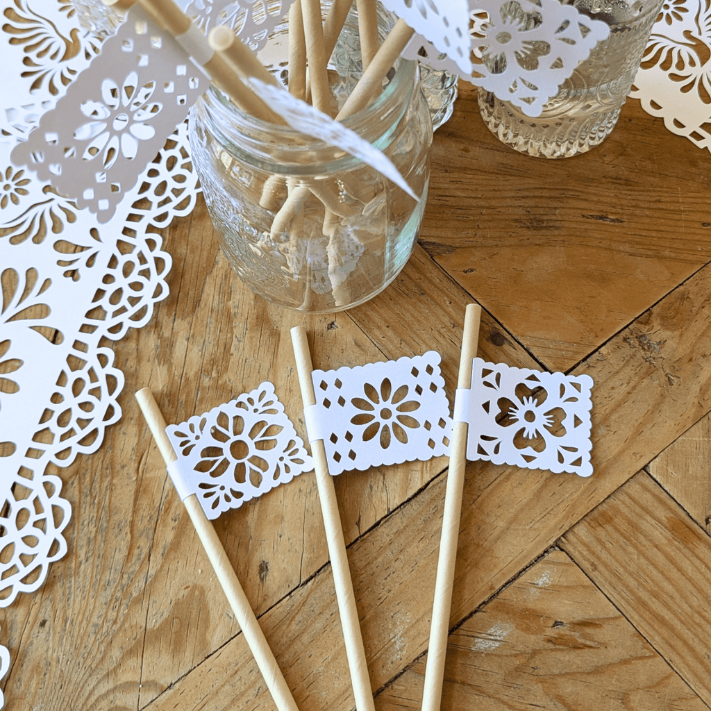 Papel picado party straws with white shimmer flags on kraft straws